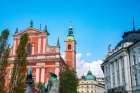 Slovenia, Ljubljana. Square and statues in front of church. Art Print